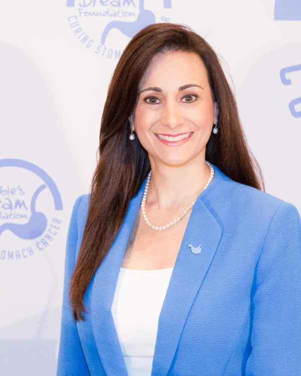 A picture of Debra Zelman in a periwinkle blue blazer